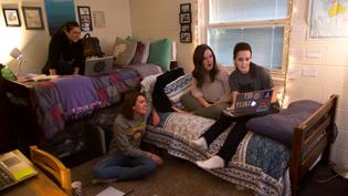 Four female students hanging out in one of Cedarville's dorm rooms